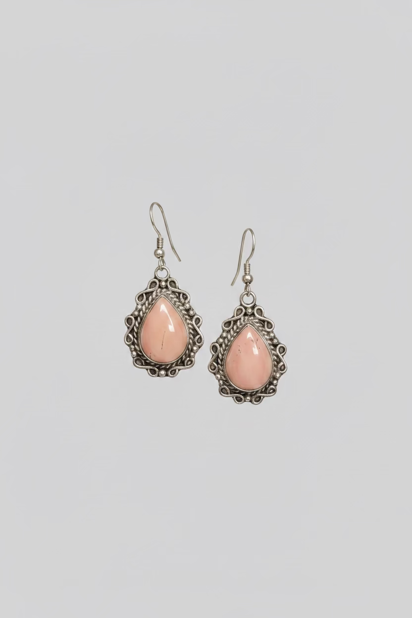 Pair of pink teardrop earrings on a black card with 'Sterling Silver' text.