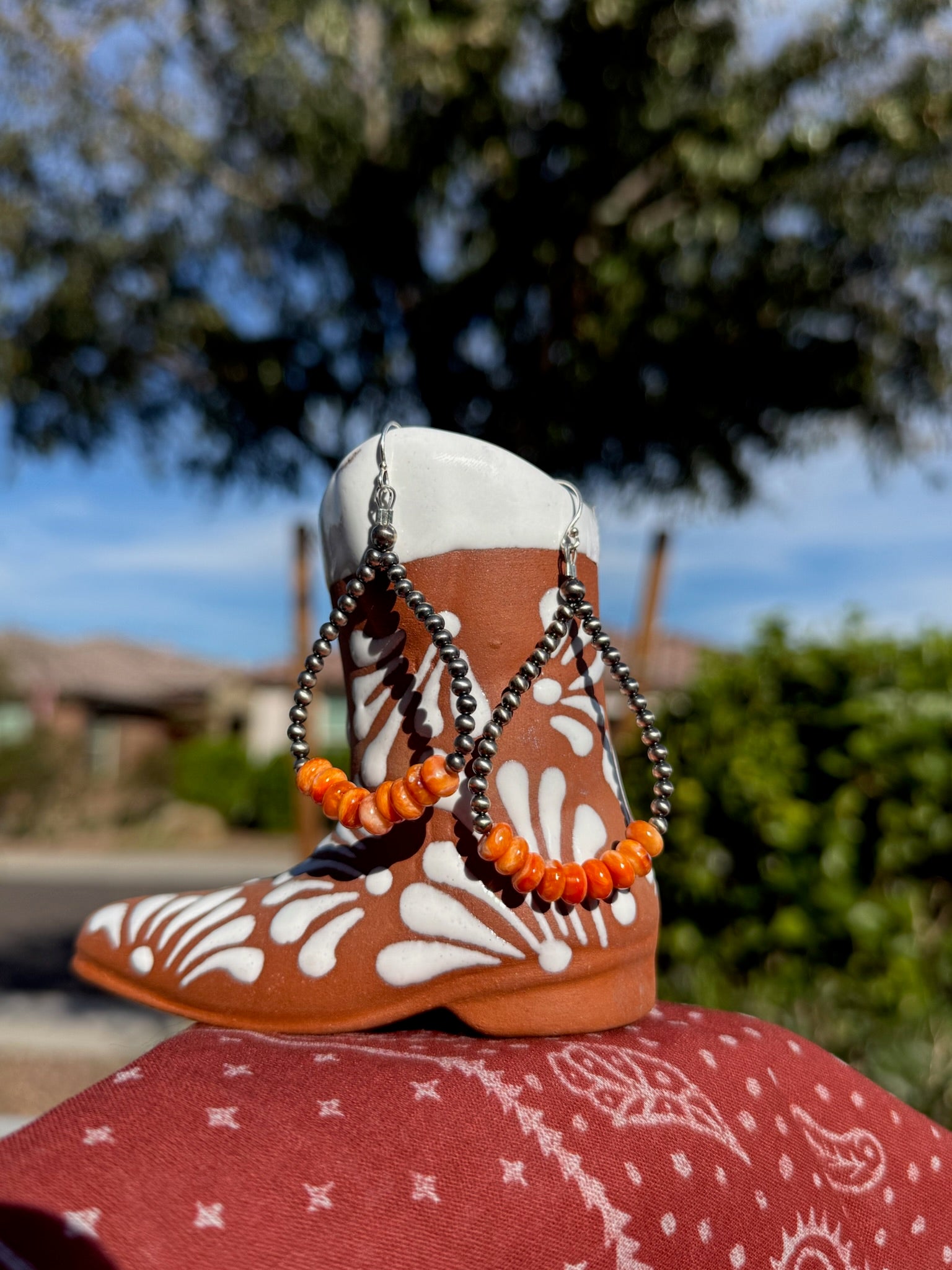 Silver pearl w/ orange spiny loop earrings